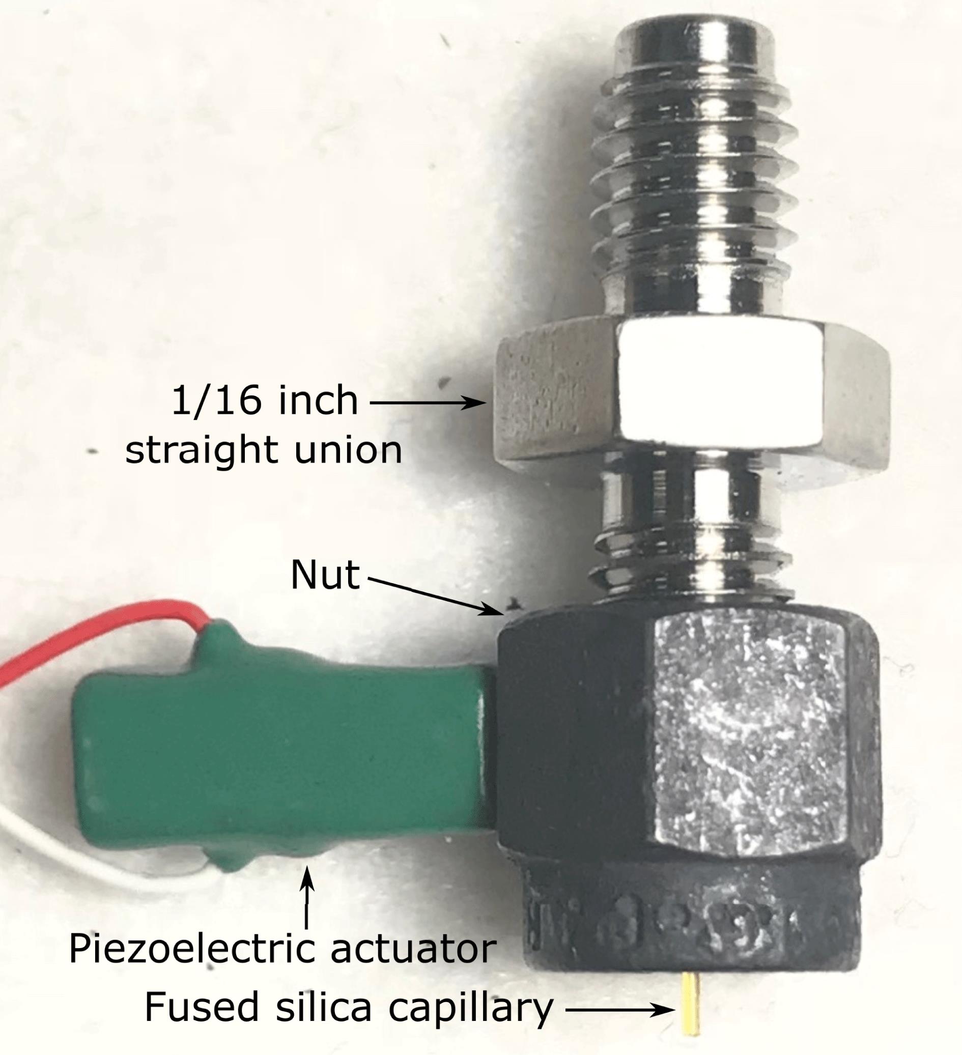 Liquid microjet nozzle assembly composed of a $1/16$ inch Swagelok fitting, Vespel ferrule, $30~\unicode[STIX]{x03BC}\text{m}$ inner diameter glass capillary tube, and locking nut with affixed piezoelectric actuator for droplet formation.